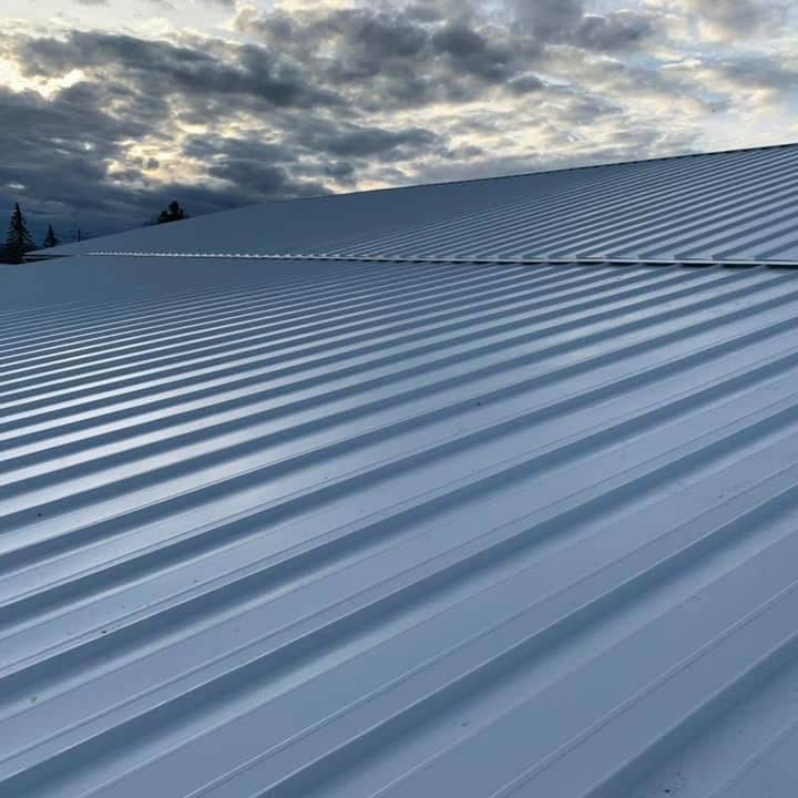 Wide standing-seam metal roof under a dramatic Yakima Valley sky